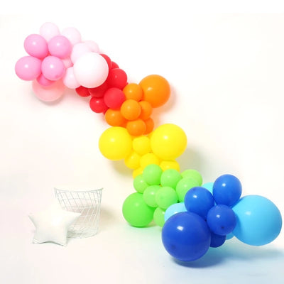 Rainbow balloon garland for a pride party background. Balloons by Badass Balloon Co. 
