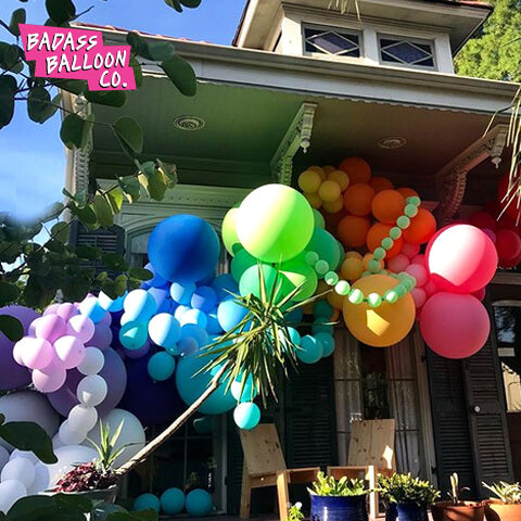 House decorated with a rainbow balloon garland. Balloons by Badass Balloon Co. 